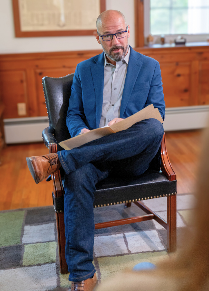 Photo of Dr. Andrew Neville with a patient in his office.